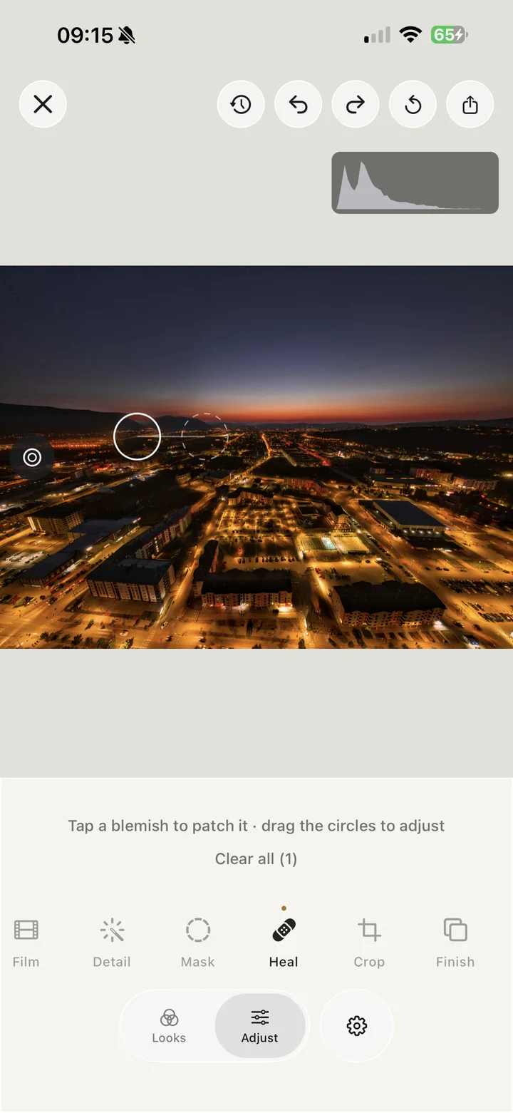The Iris heal tool patching a blemish in a night cityscape